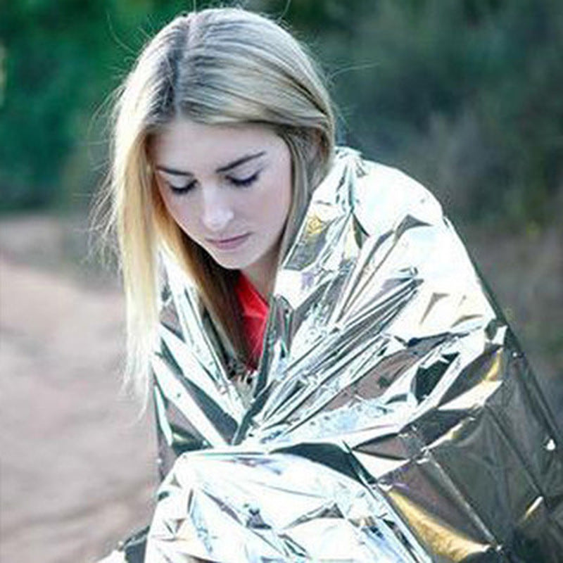 Human Body Hypothermia Lifesaving Emergency Blanket in Outdoor Field