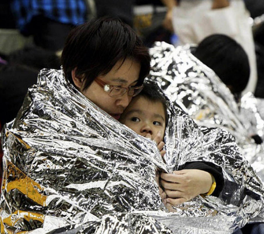 Human Body Hypothermia Lifesaving Emergency Blanket in Outdoor Field