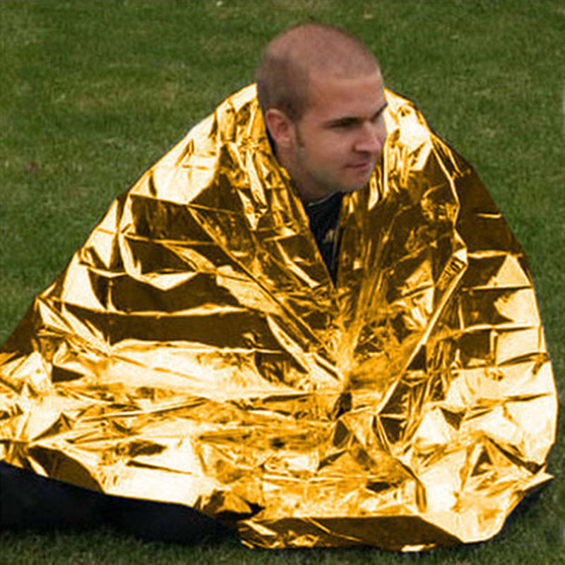 Human Body Hypothermia Lifesaving Emergency Blanket in Outdoor Field